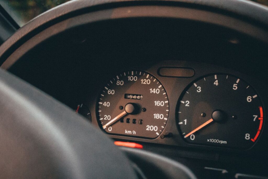 Detailed interior view of a car dashboard featuring speedometer and odometer readings.
